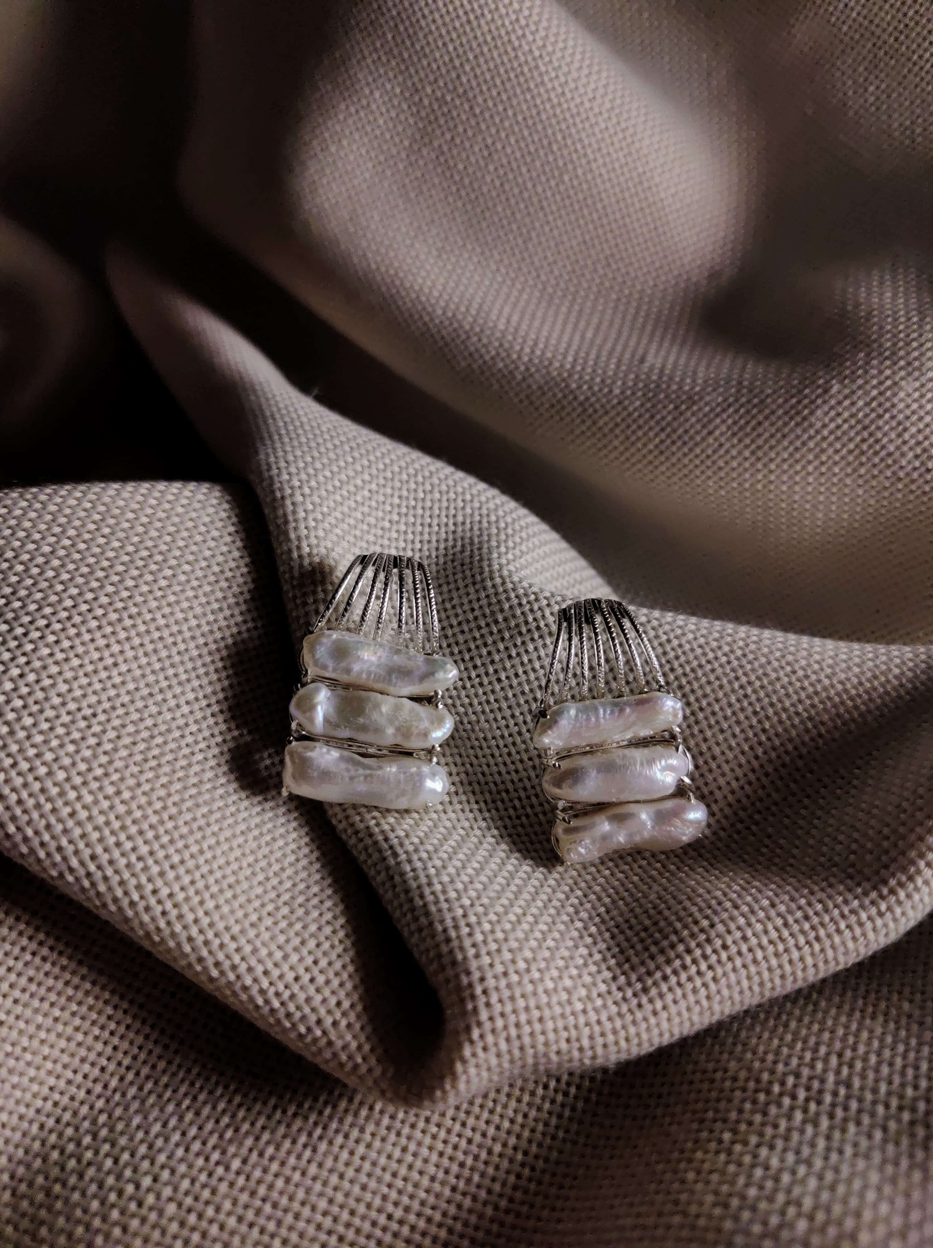 Orchid: A handcrafted Earrings featuring Pearl and hues of White.