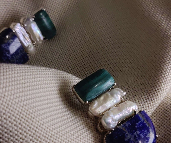 Bletilla: A handcrafted Earrings featuring Malachite Pearl Lapis Lazuli and hues of White Blue.