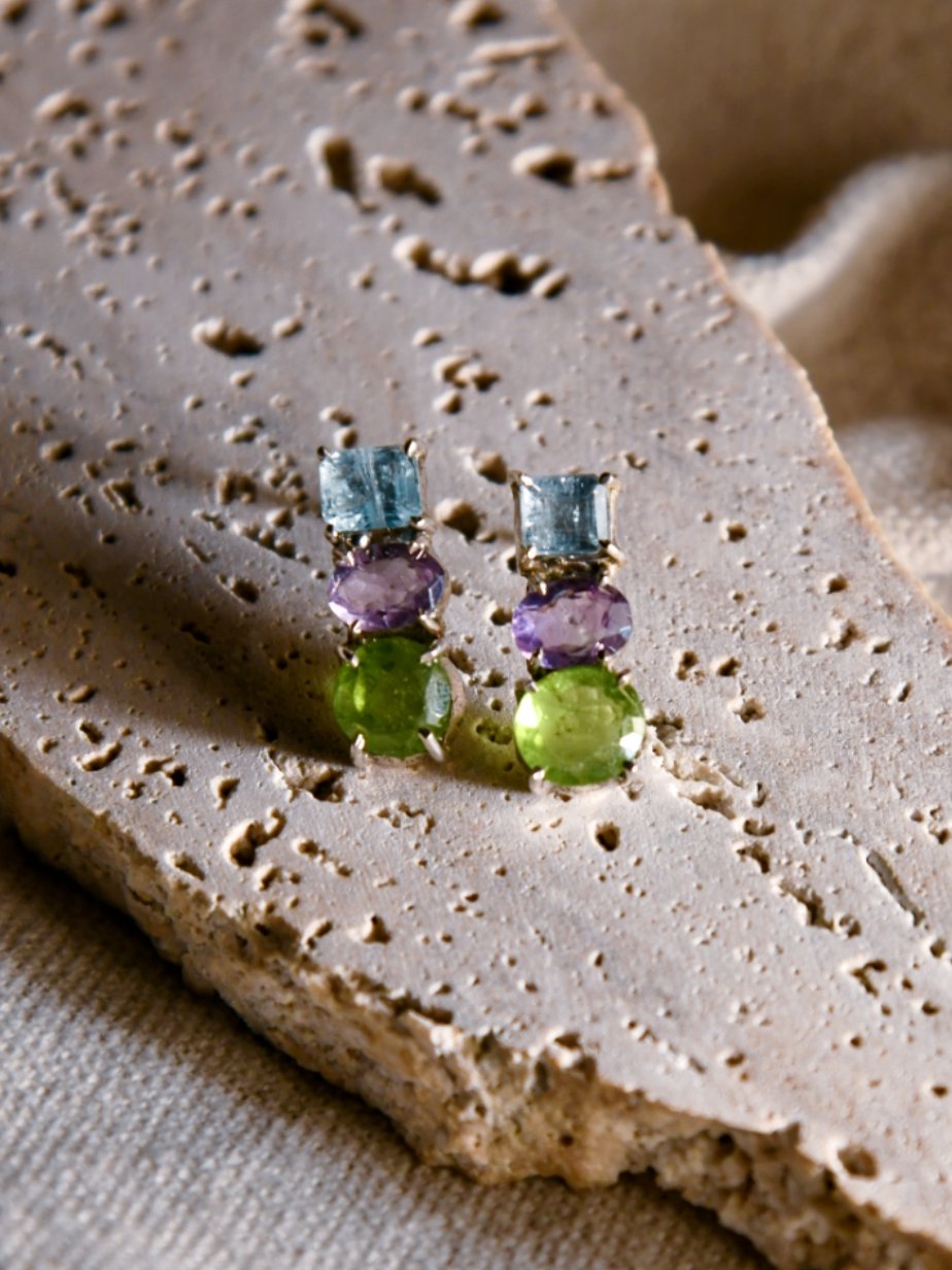 Ajisai: A handcrafted Earrings featuring Peridot Aquamarine Amethyst and hues of Blue Purple Green.