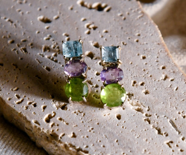 Ajisai: A handcrafted Earrings featuring Peridot Aquamarine Amethyst and hues of Blue Purple Green.