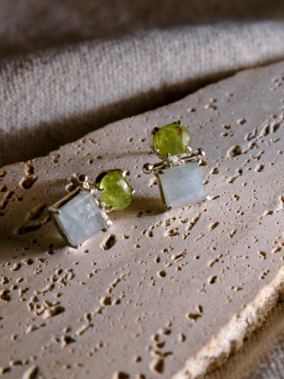 Ko: A handcrafted Earrings featuring Peridot Aquamarine and hues of Green Blue.