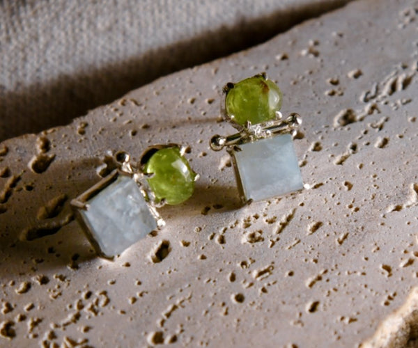 Ko: A handcrafted Earrings featuring Peridot Aquamarine and hues of Green Blue.