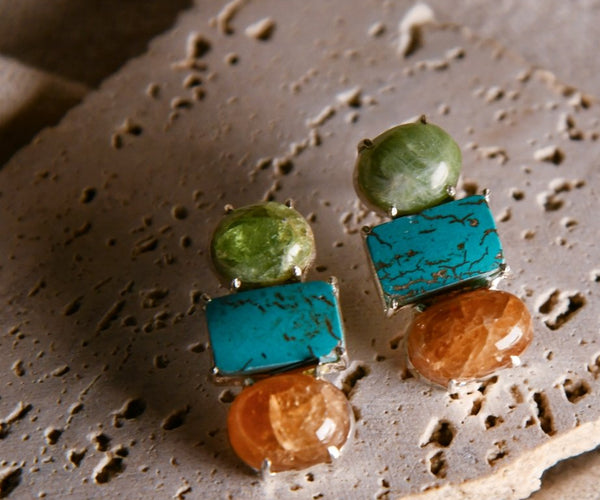 Tesu: A handcrafted Earrings featuring Sandstone Turquoise Peridot and hues of Blue Green Brown.