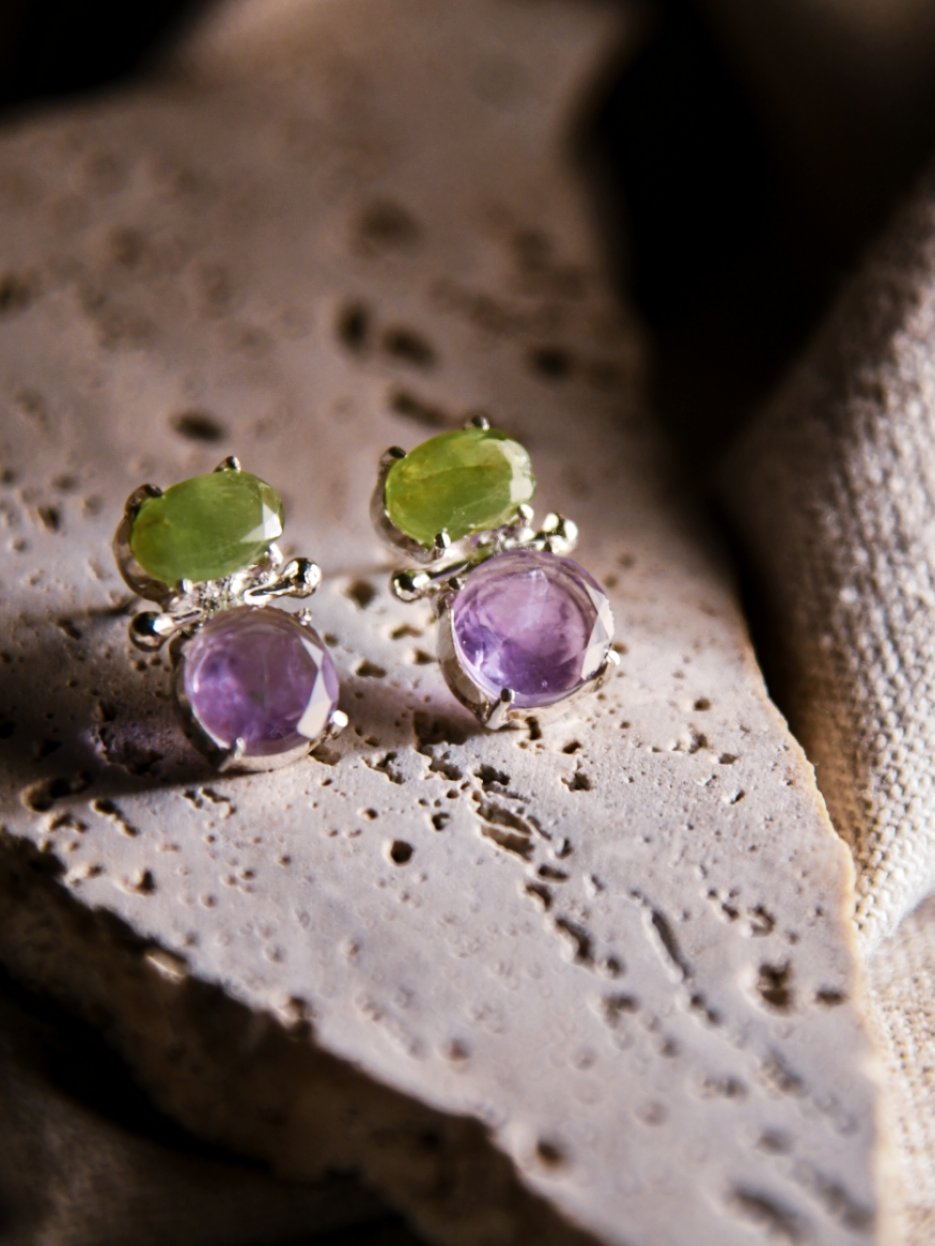 Imani: A handcrafted Earrings featuring Amethyst Peridot and hues of Green Purple.