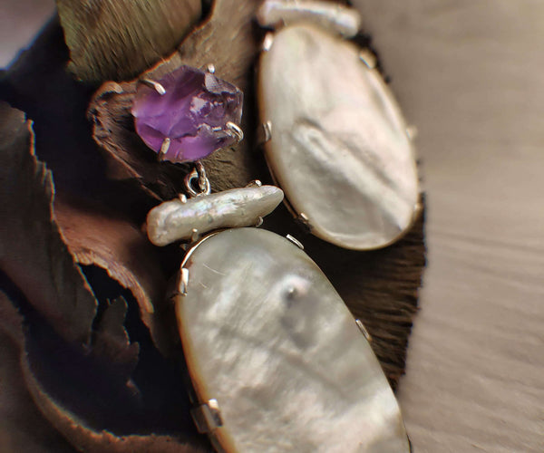 Mother: A handcrafted Earrings featuring  Mother Pearl Amethyst and hues of White Purple.