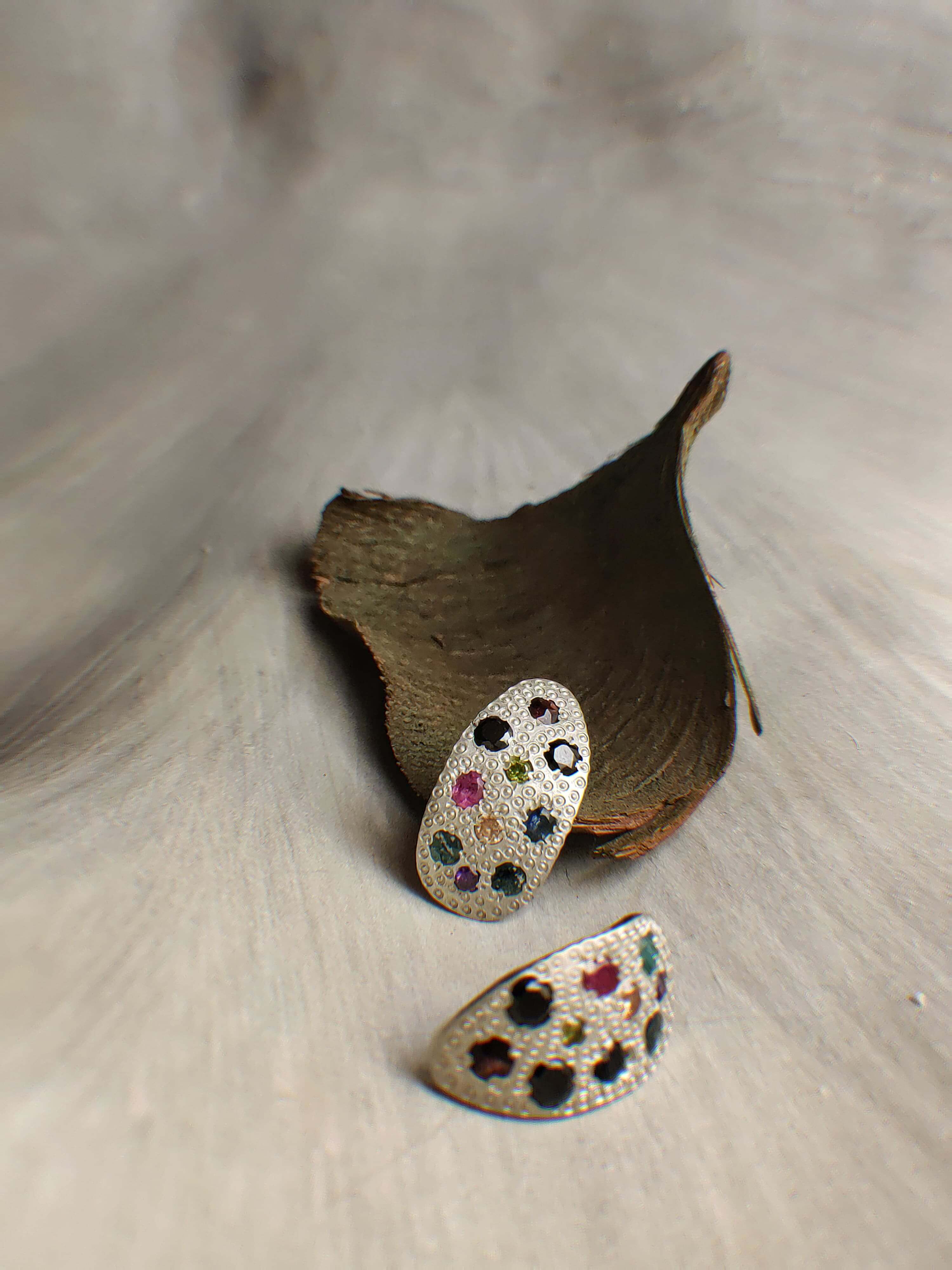 Beetlejuice: A handcrafted Earrings featuring Ruby Citrine Emerald Amethyst and hues of Red Green Yellow Purple.
