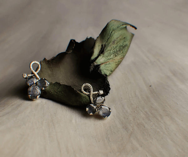 Grey: A handcrafted Earrings featuring Sapphire and hues of Grey.