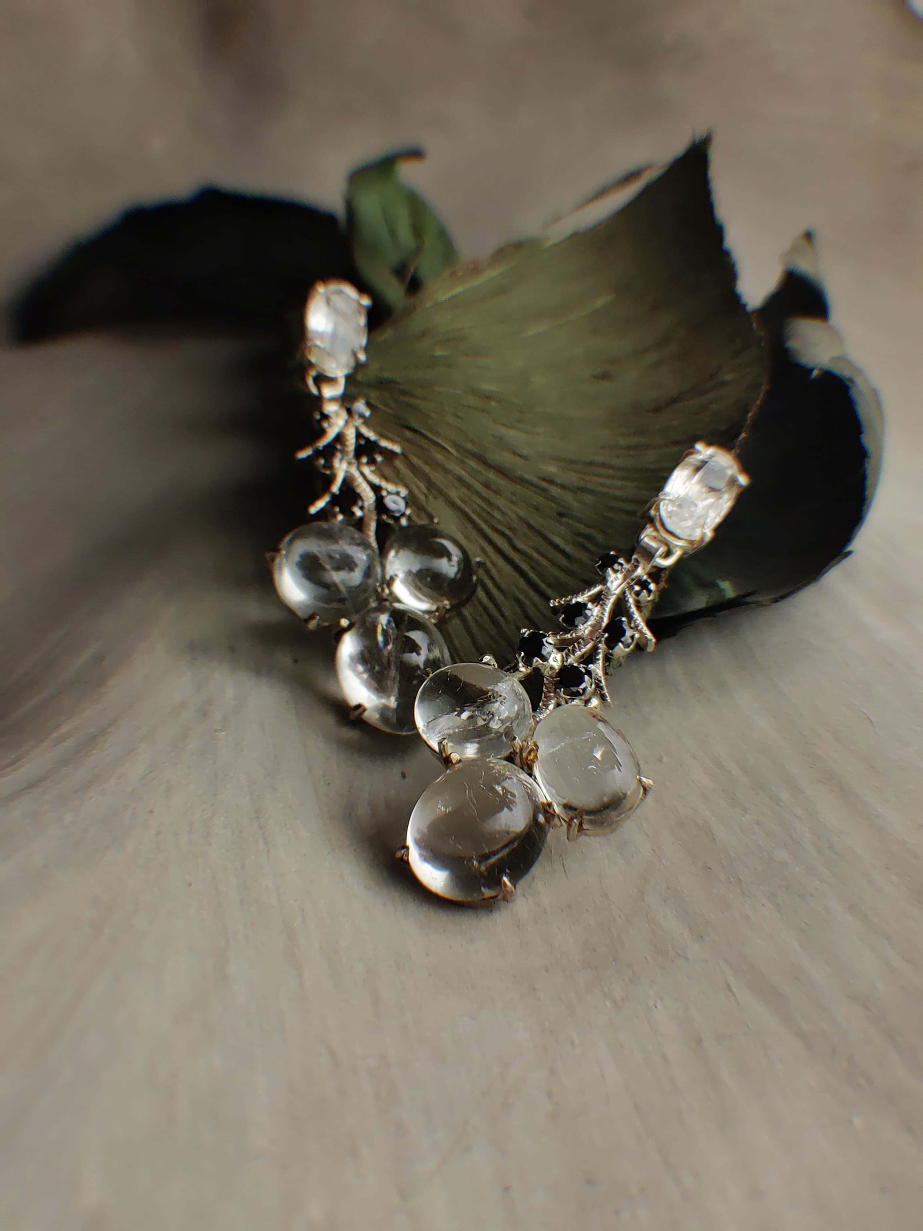 Artic Pearls: A handcrafted Earrings featuring Moonstone Onyx and hues of Black White.