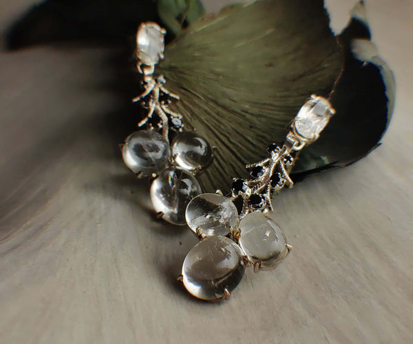 Artic Pearls: A handcrafted Earrings featuring Moonstone Onyx and hues of Black White.