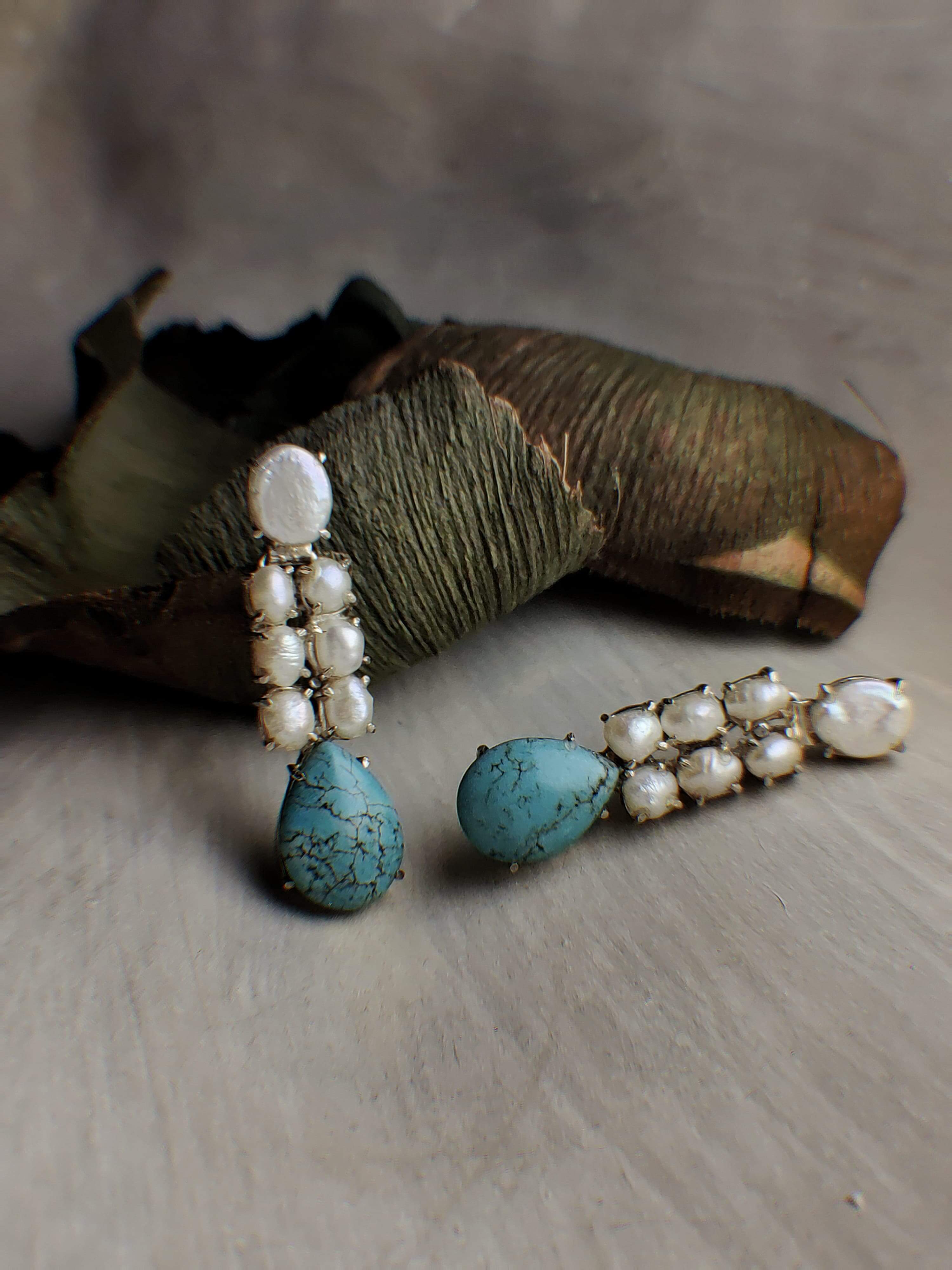 Eva: A handcrafted Earrings featuring Pearl Turquoise and hues of White Blue.