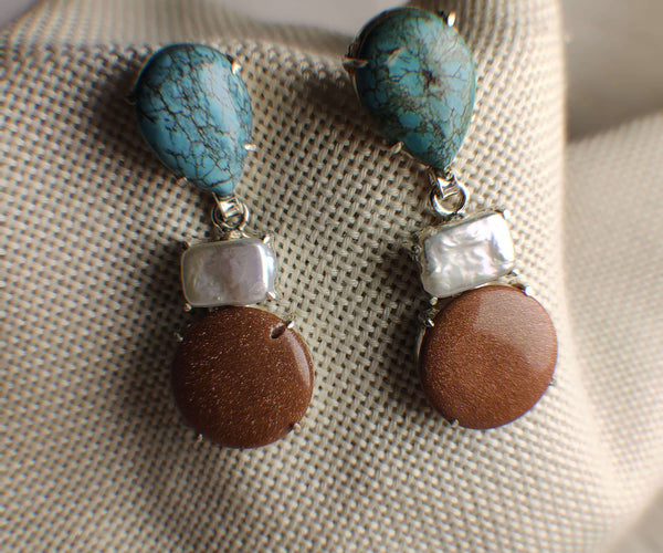 Aether: A handcrafted Earrings featuring Turquoise Pearl Sandstone and hues of Blue White Brown.