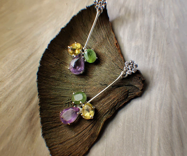 Hope: A handcrafted Earrings featuring Amethyst Citrine Peridot and hues of Purple Green Yellow.