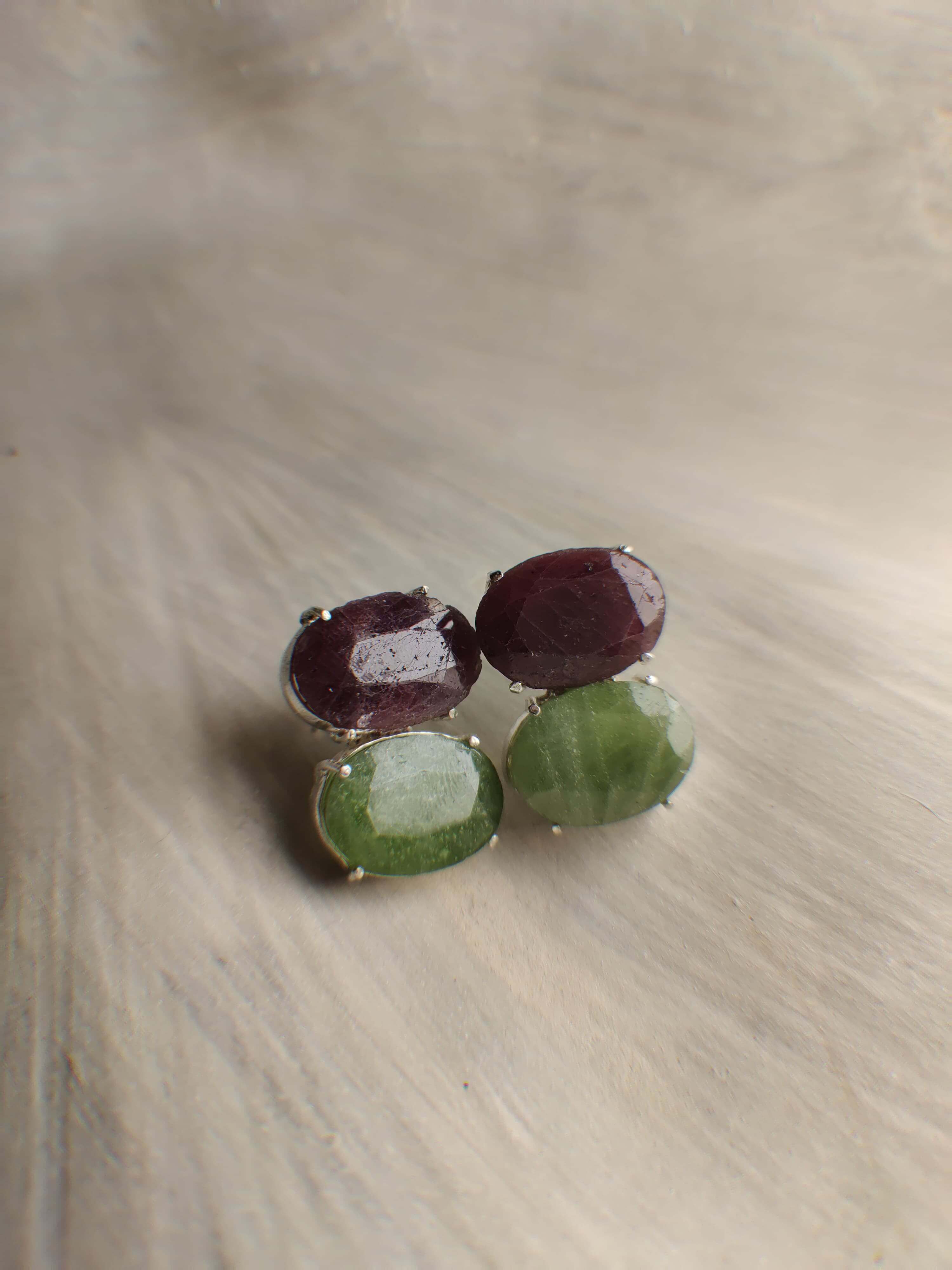 Nox: A handcrafted Earrings featuring Ruby Peridot and hues of Red Green.