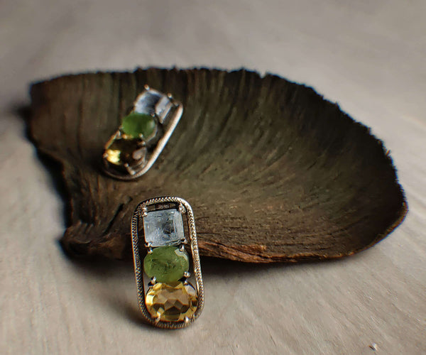 Hemlock: A handcrafted Earrings featuring Aquamarine Topaz Peridot and hues of Blue Green Yellow.