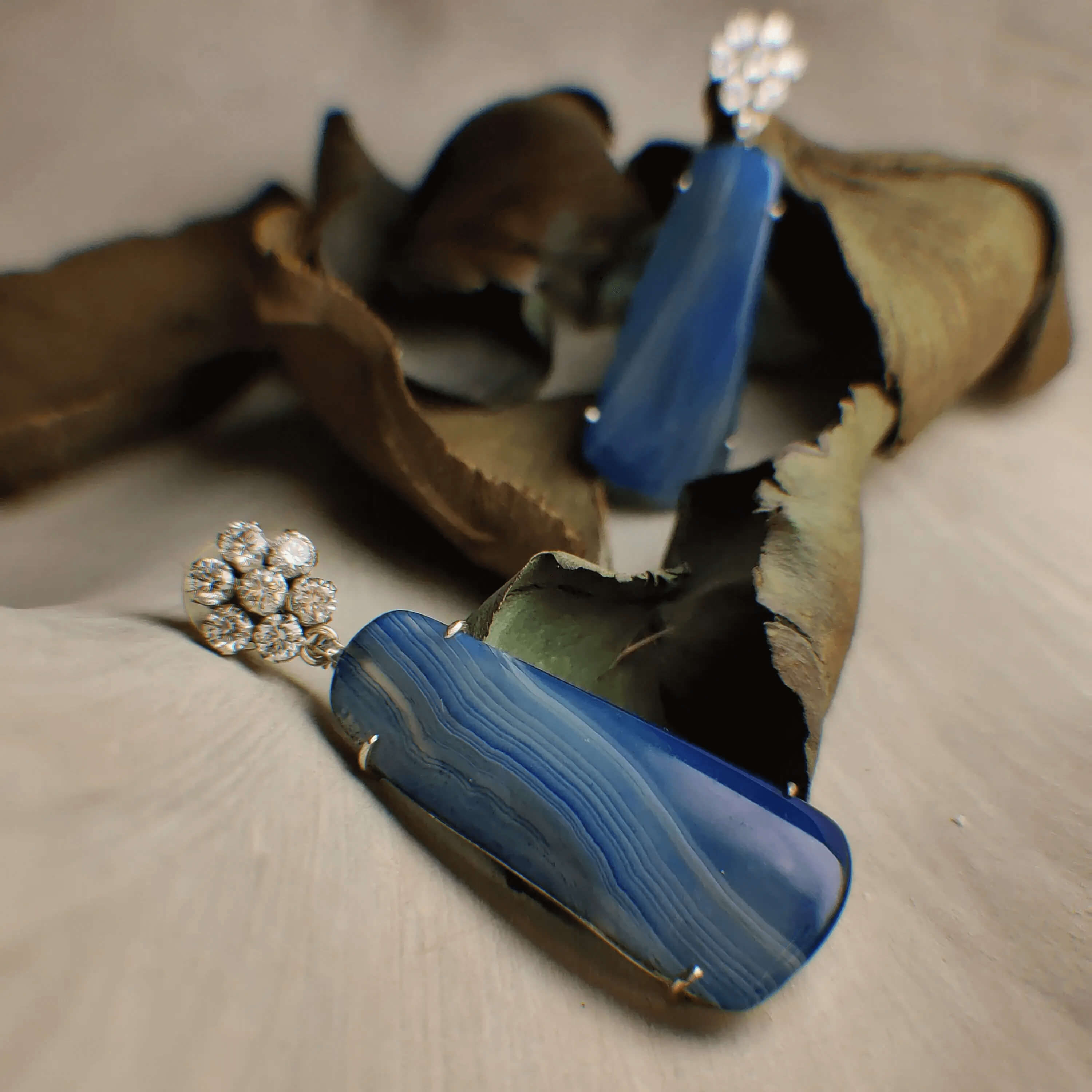 Blue wasp: A handcrafted Earrings featuring Agate  Zirconia and hues of Blue White.