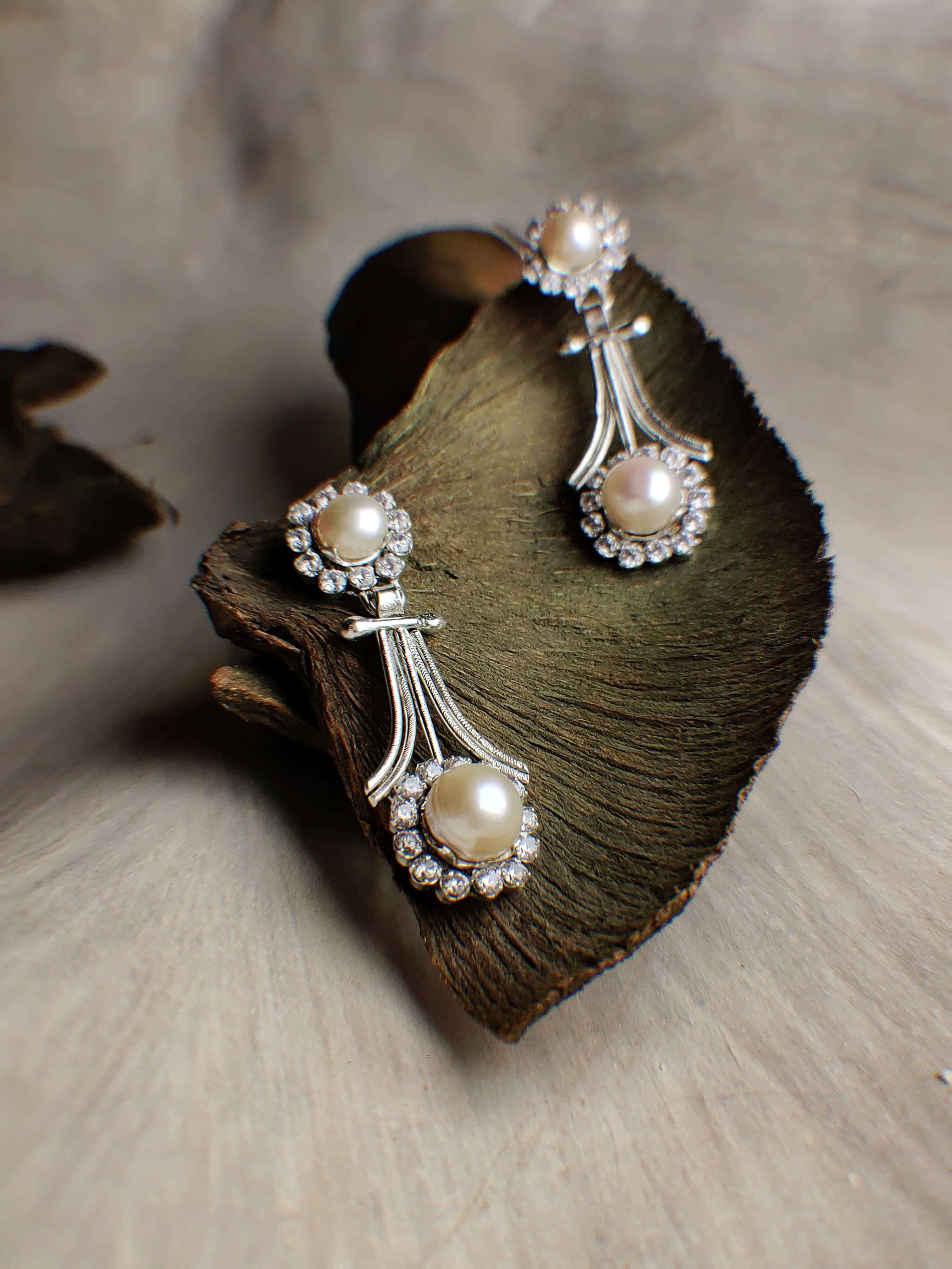 Foxglove: A handcrafted Earrings featuring Pearl  Zirconia and hues of White.
