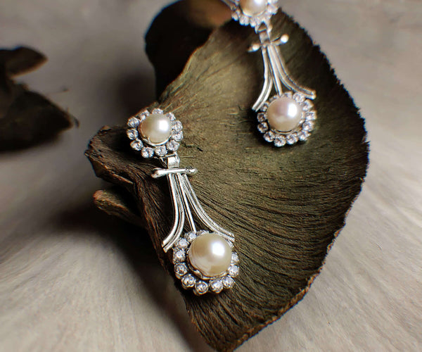 Foxglove: A handcrafted Earrings featuring Pearl  Zirconia and hues of White.