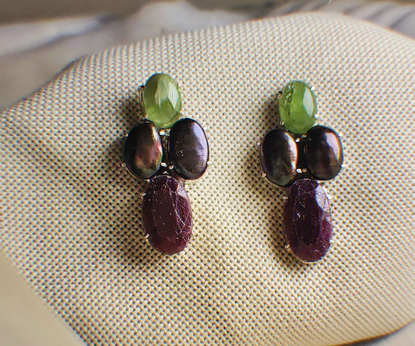 Four: A handcrafted Earrings featuring Pearl Peridot Ruby and hues of Red Green Grey.