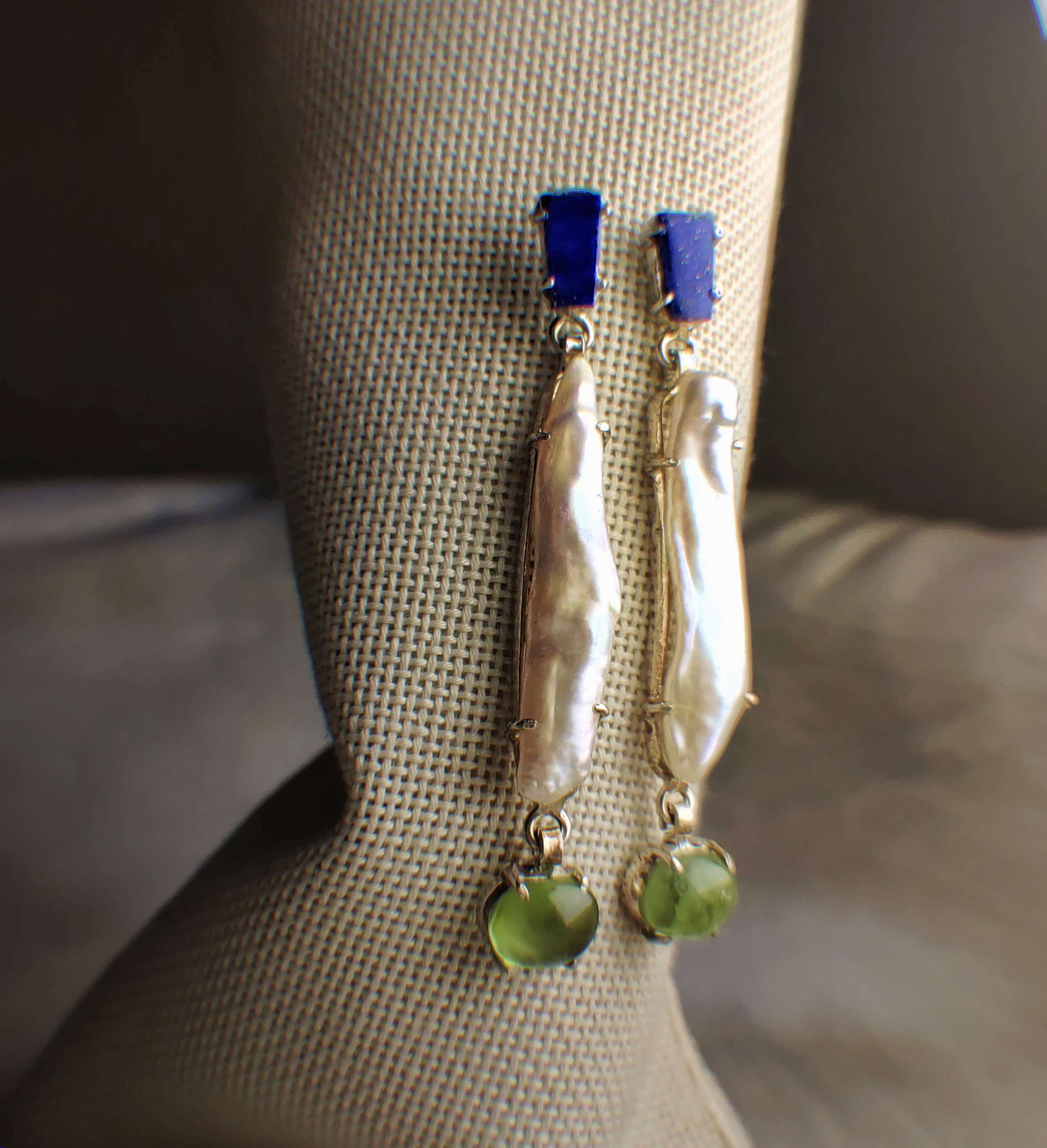 Jade: A handcrafted Earrings featuring Lapis Lazuli Pearl Peridot and hues of Blue White Green.