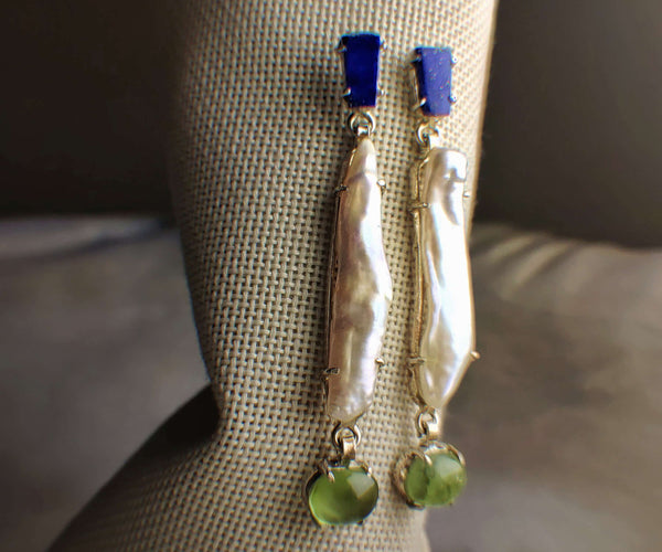 Jade: A handcrafted Earrings featuring Lapis Lazuli Pearl Peridot and hues of Blue White Green.