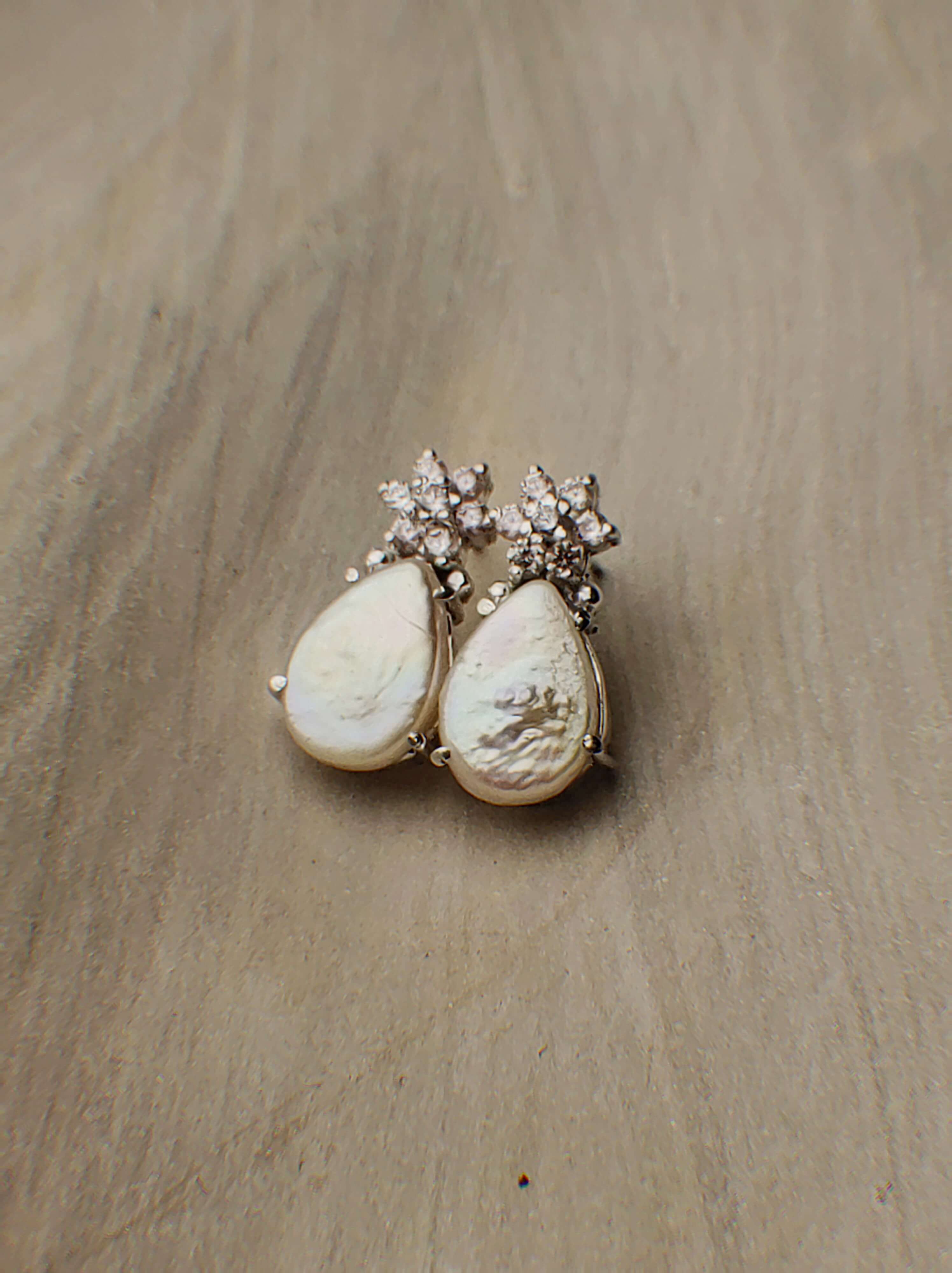 Lia: A handcrafted Earrings featuring  Zirconia Pearl and hues of White.