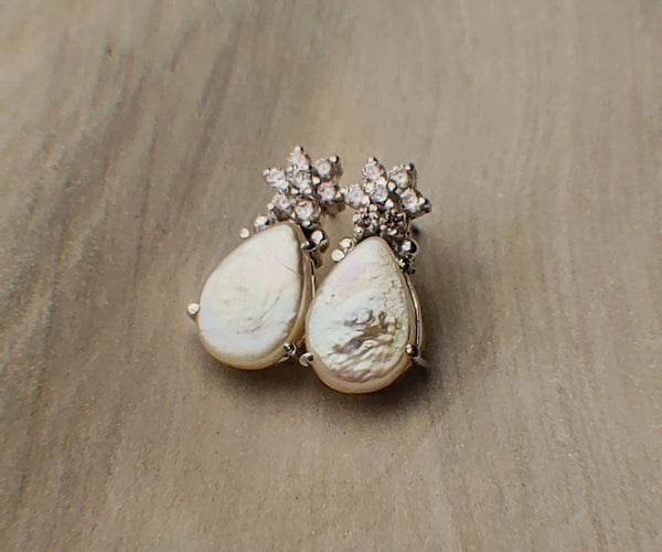 Lia: A handcrafted Earrings featuring  Zirconia Pearl and hues of White.