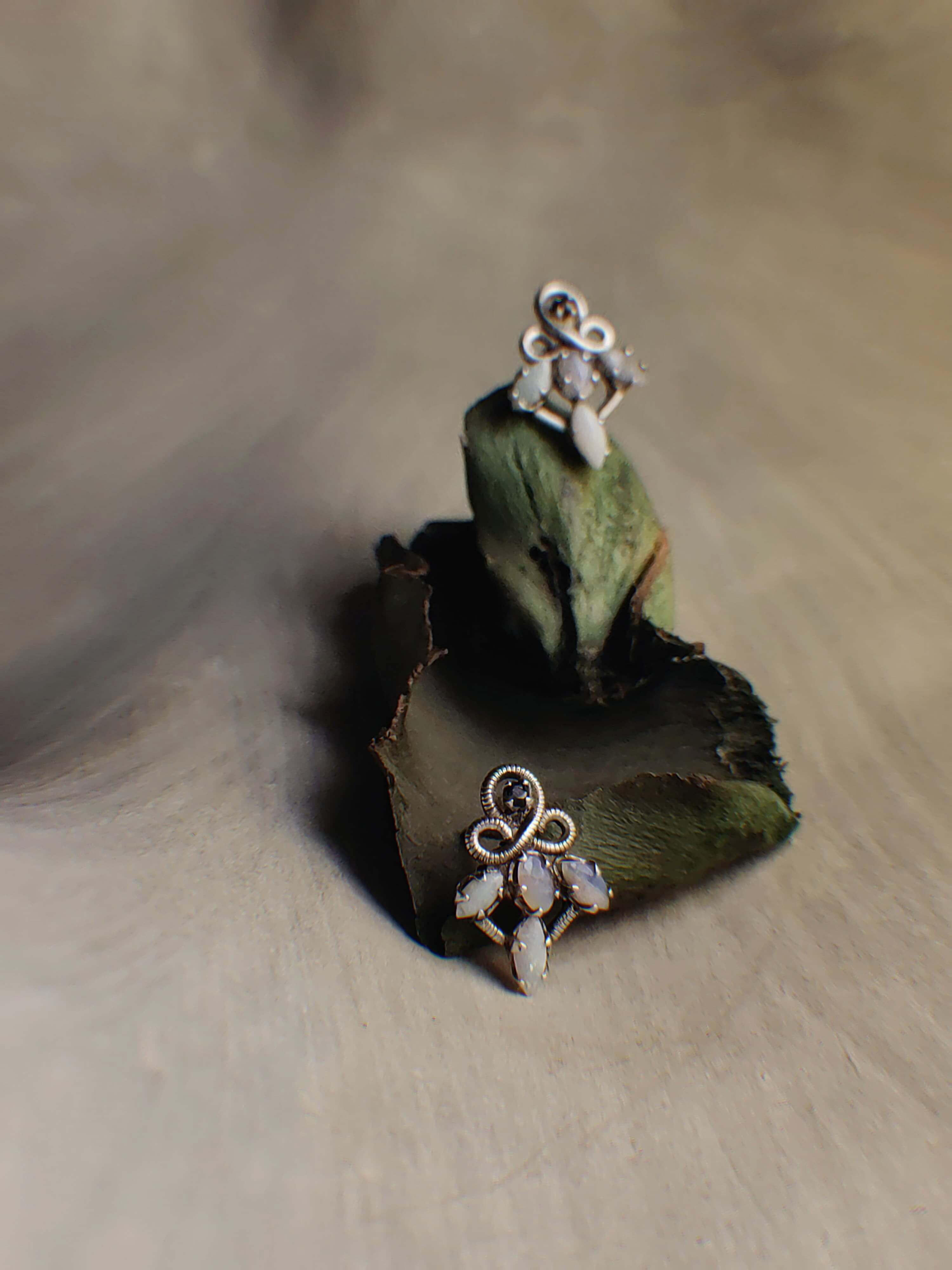 Medora: A handcrafted Earrings featuring Opal and hues of White.