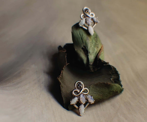 Medora: A handcrafted Earrings featuring Opal and hues of White.