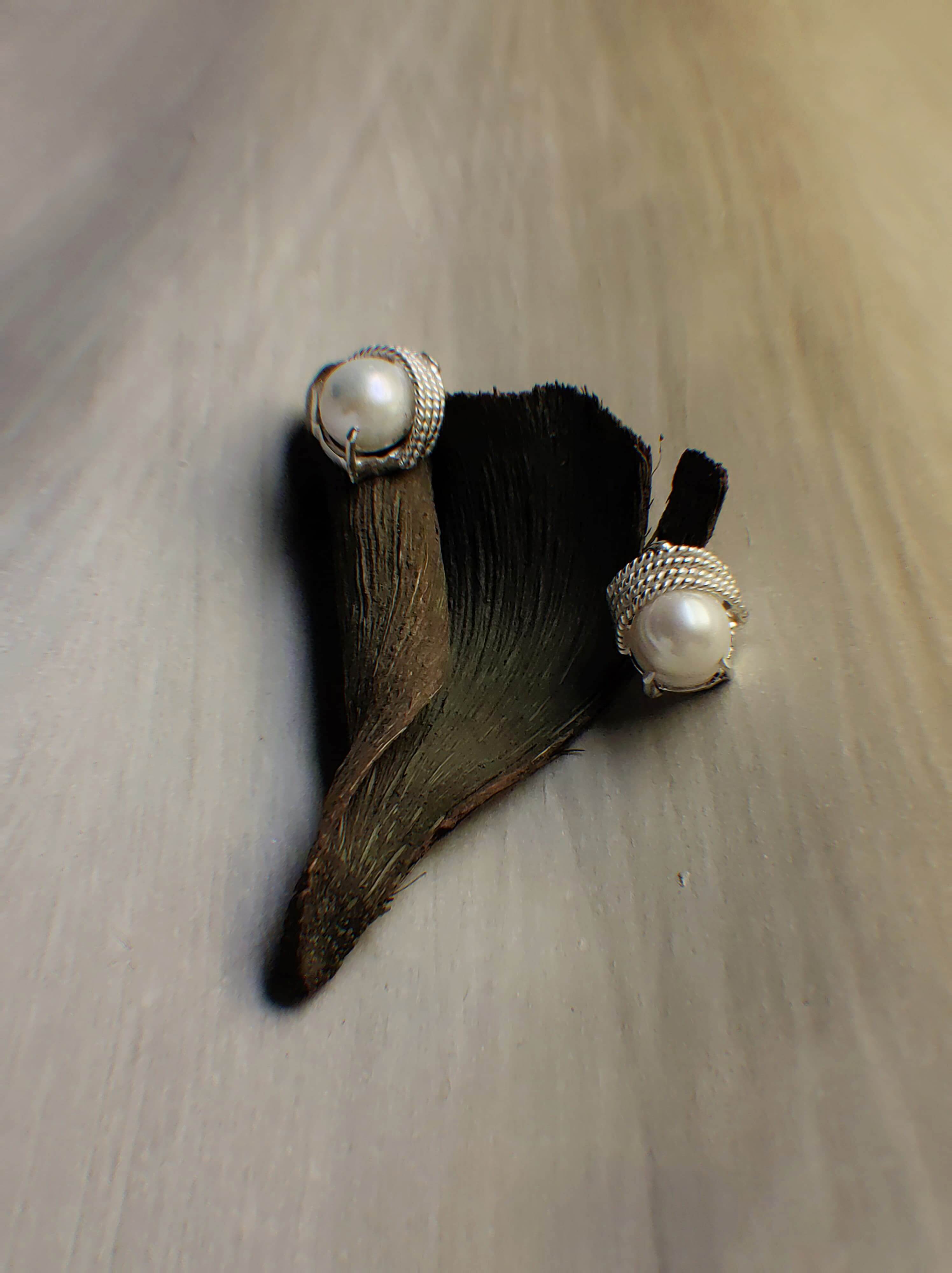 Selena: A handcrafted Earrings featuring Pearl and hues of White.