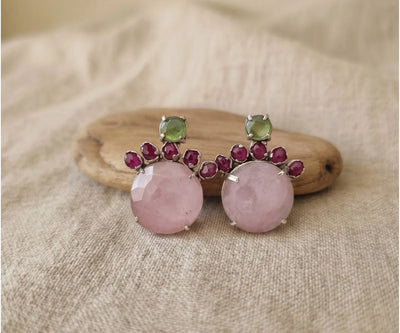 Elegant Noor silver pieces containing Peridot, Ruby, and Rose Quartz in green, red, and pink.
