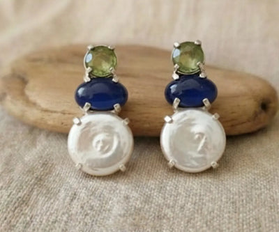 Silver Rima jewelry showing off Pearl, Lapis Lazuli, and Peridot in white, blue, and green.