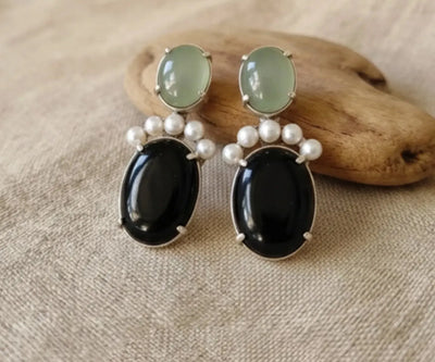 Beautiful Waha studs set with Onyx, Pearl, and Aquamarine in white, black, and blue.