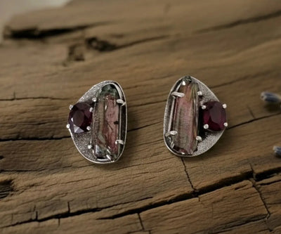 Aura drop earrings highlighting Ruby and Pearl in red and grey.