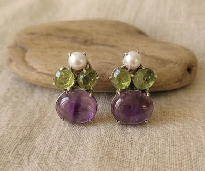 Handcrafted Rhea earrings boasting Peridot, Amethyst, and Pearl in purple, green, and white.